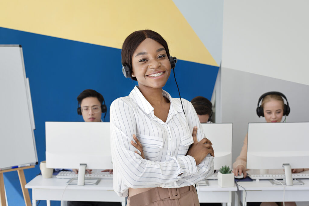 African American female tech support operator ready to offer IT support services in call center